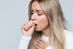 girl coughing with sickness from stress